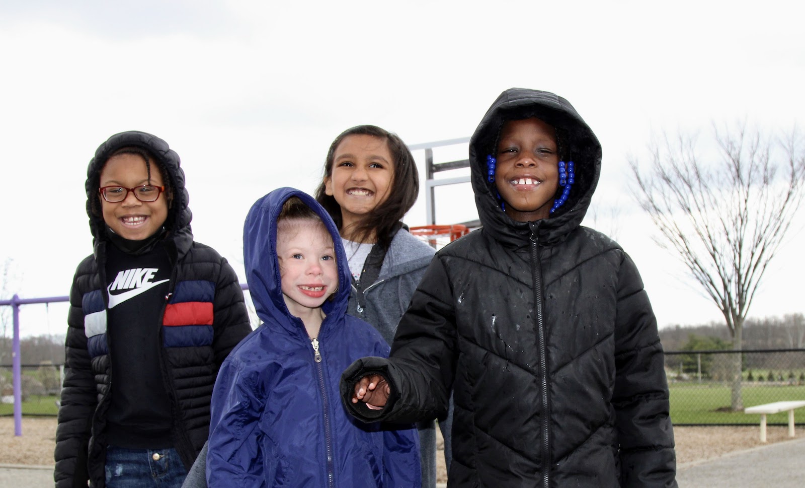 four girls on a winter playground