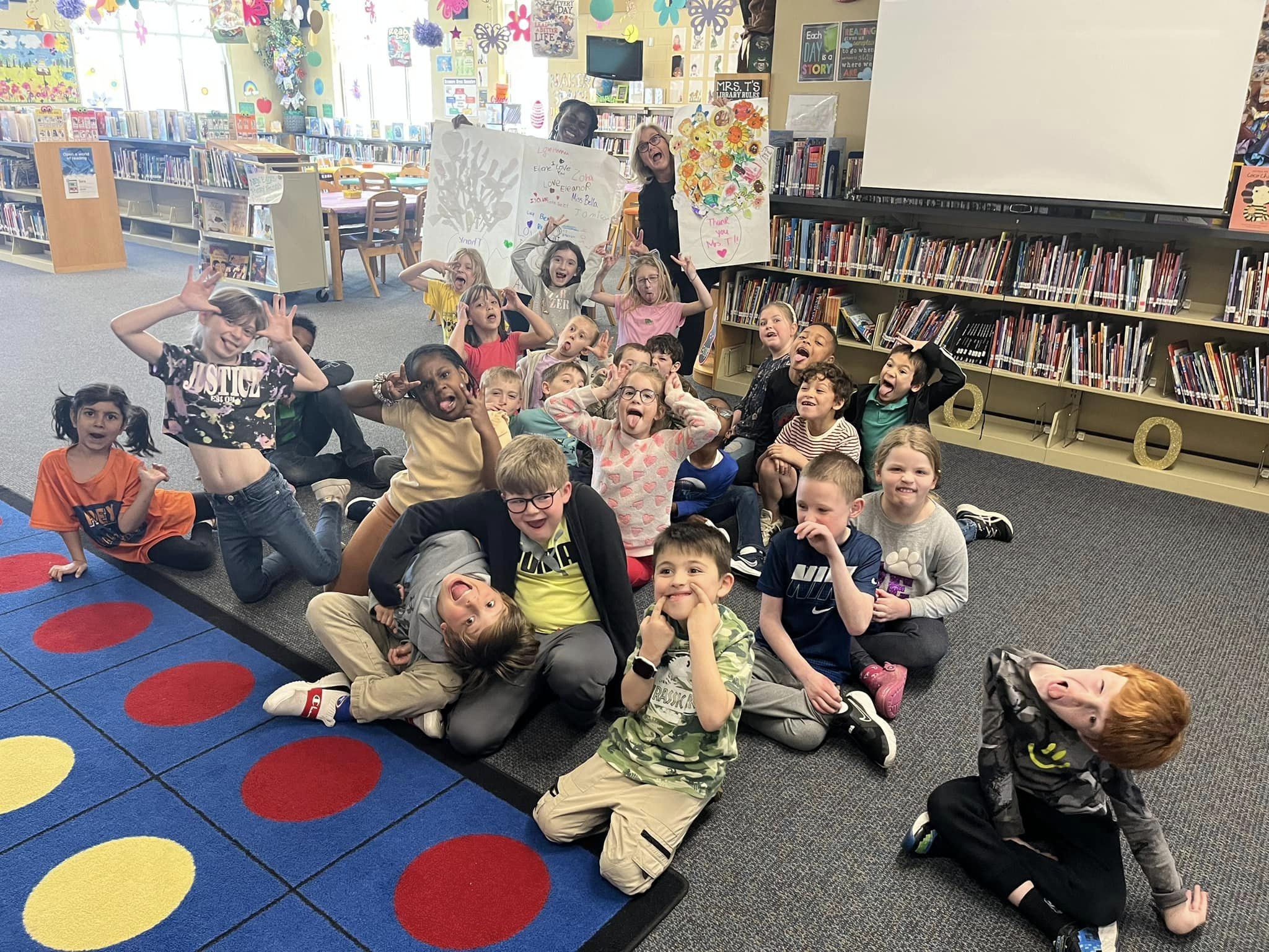 a group of children makinf fun faces in the Sycamore Creek Elementary Media Center