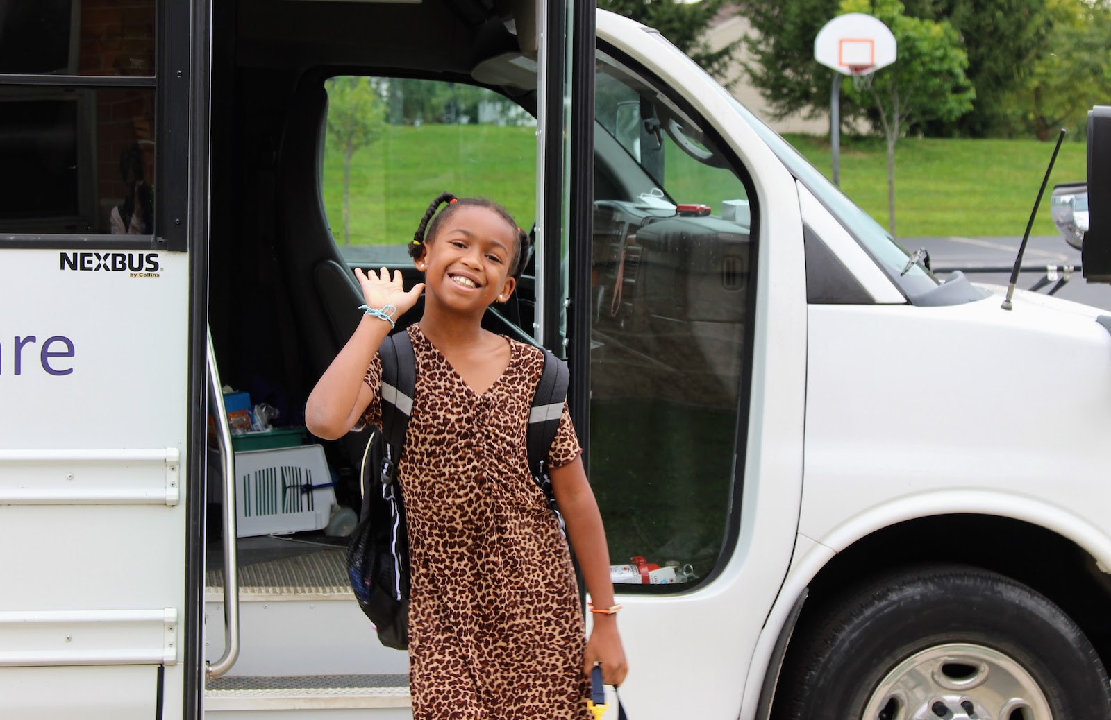 girl waving at camera 