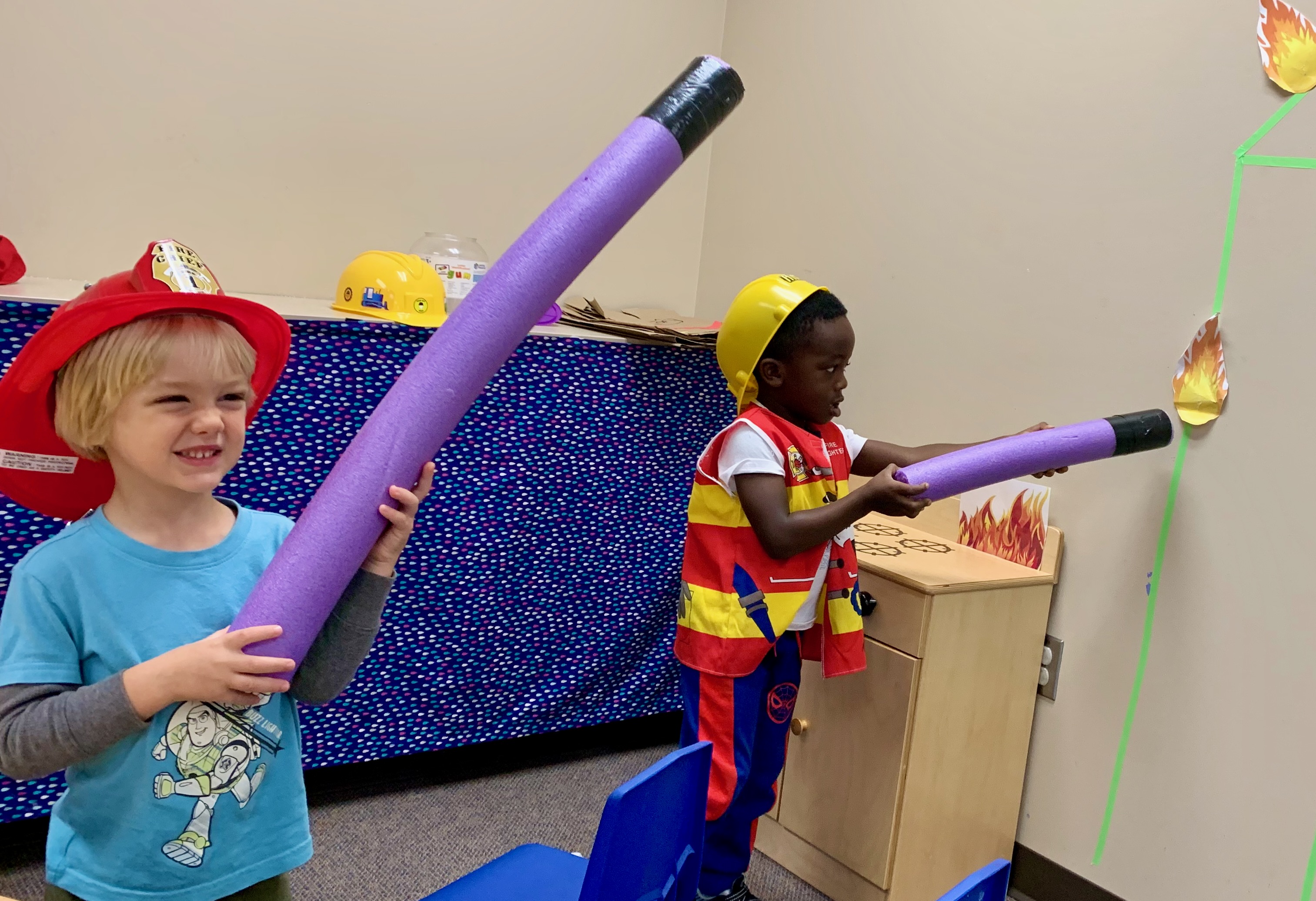 Children playing at putting out a pretend fire