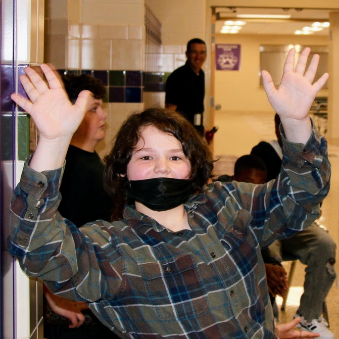 junior high student waving