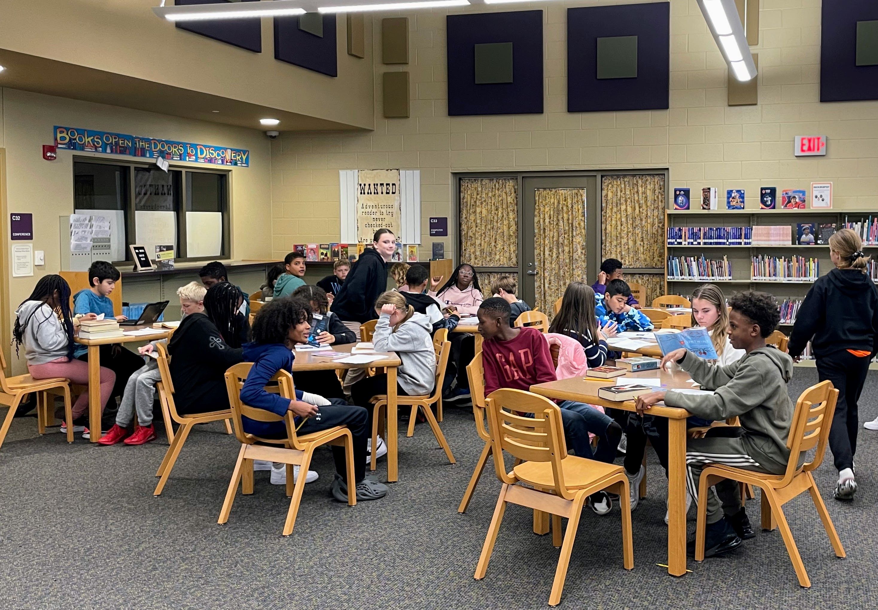 Students interacting with each in the Toll Gate Middle School Media Center