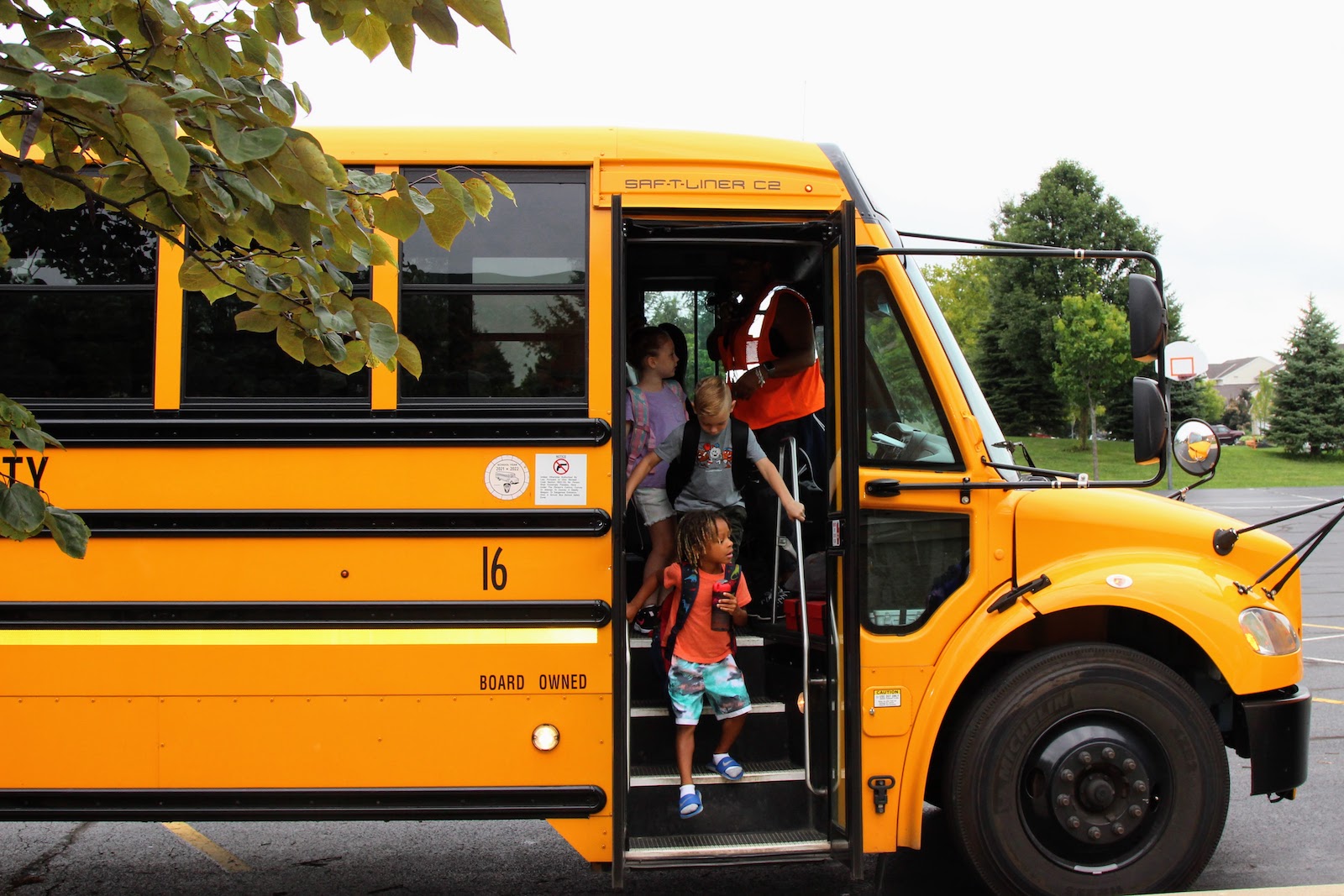 children getting off a school bus