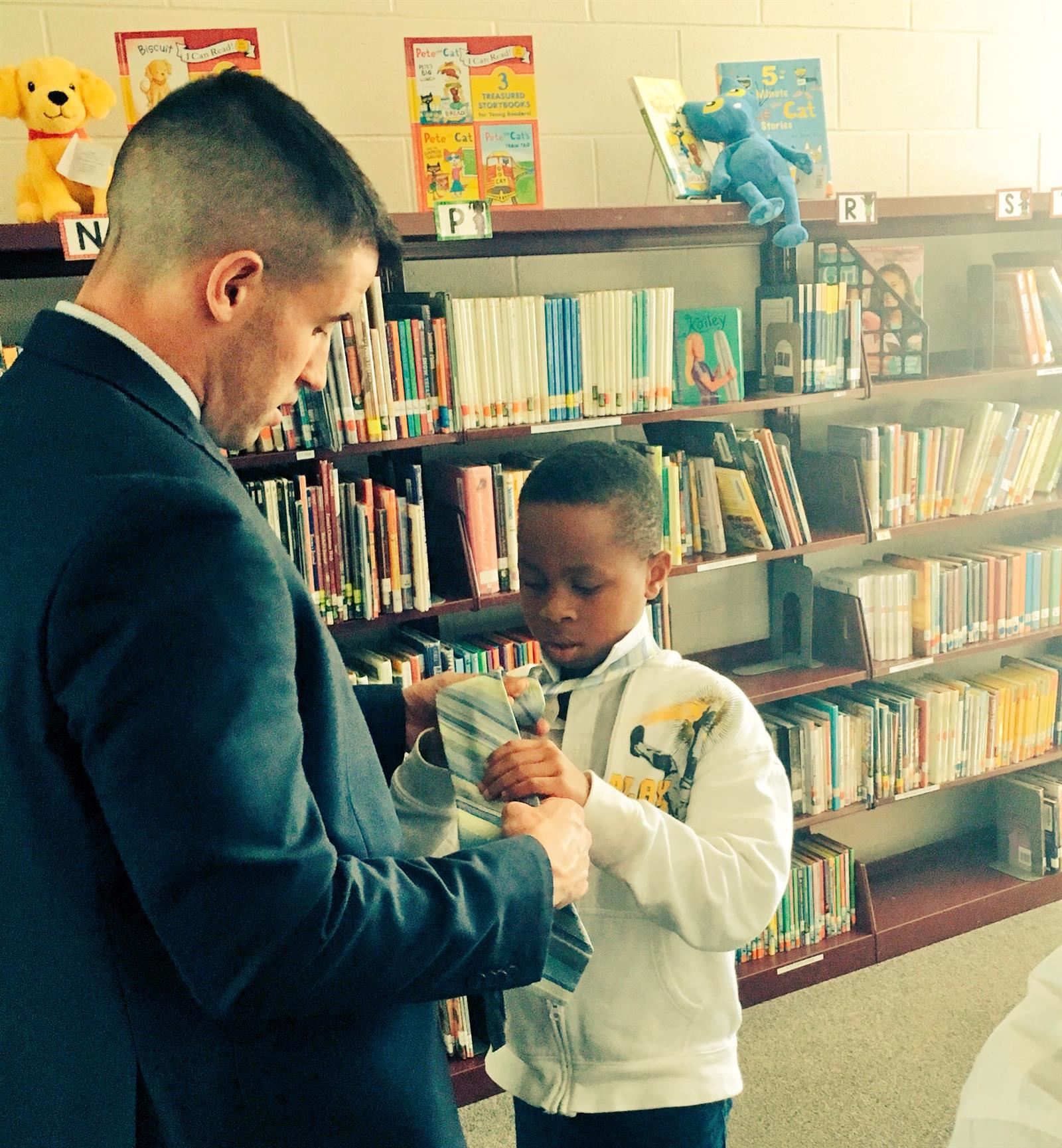 A student in the Young Gents program learn to tie a tie.