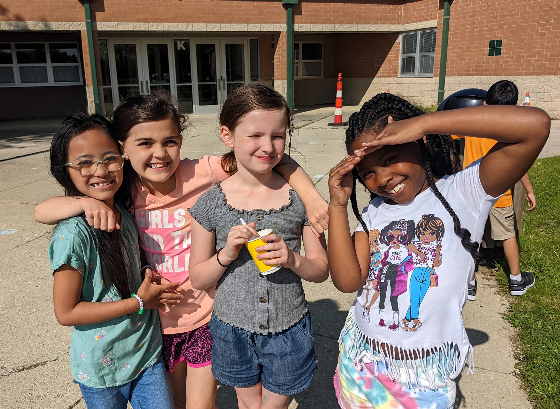 four girls smiling in the sun