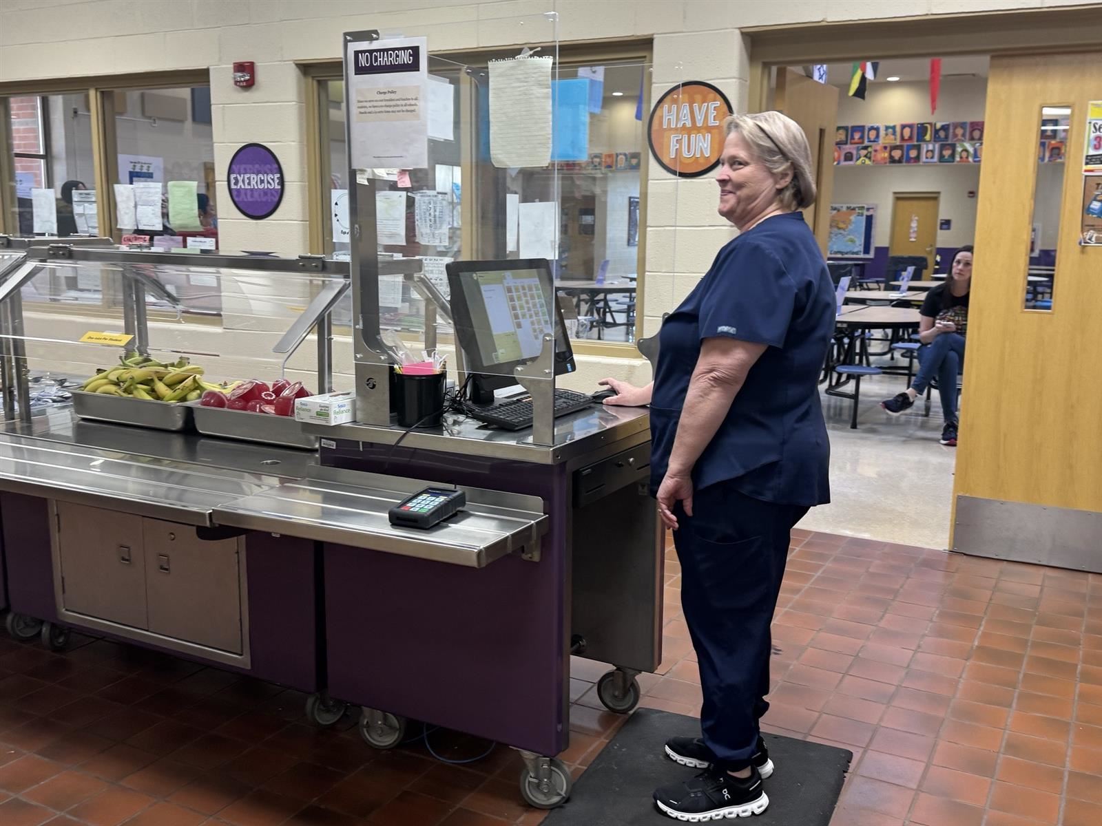 Food Service Worker Standing in front of cashier