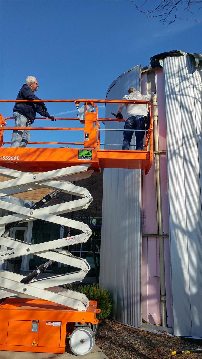 Russ Littrell and Chris Ballinger fixing a roof drain at Pickerington High School Central