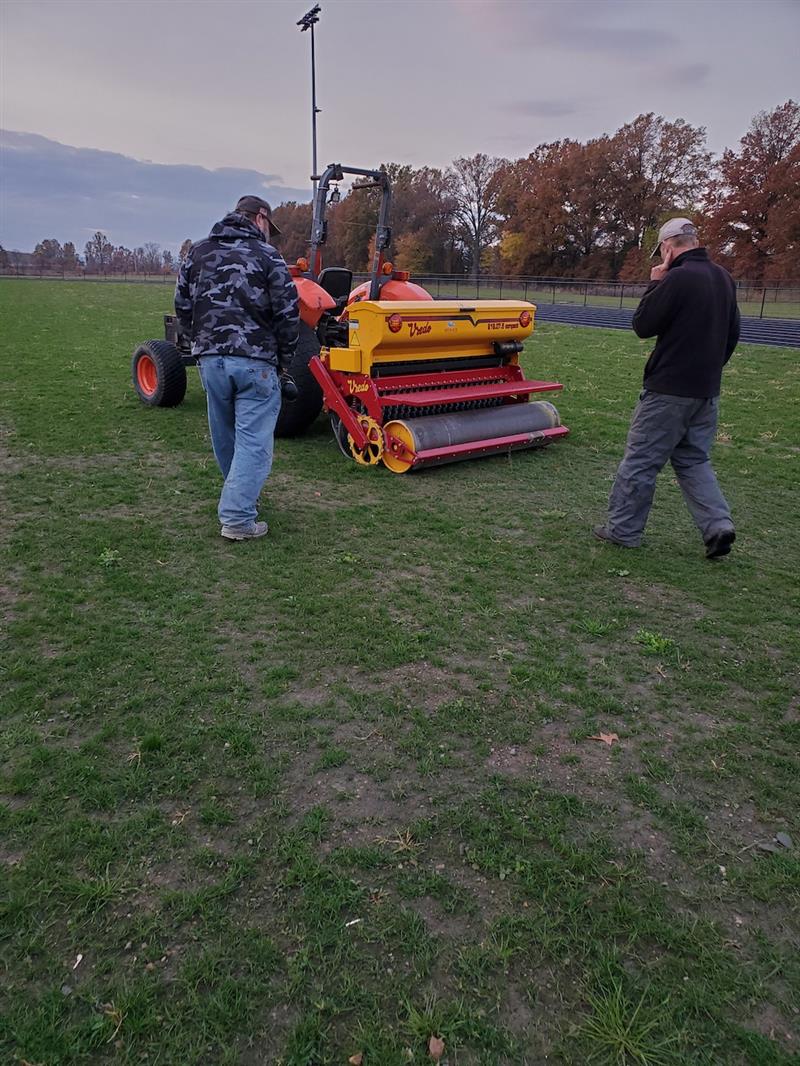 Ken Chenetski calibrating the Vredo seeder at the McGill stadium