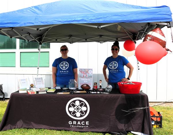 two women at the Grace Fellowship vendor booth