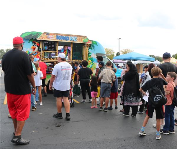 Attendees line up at the Kona Ice Truck.