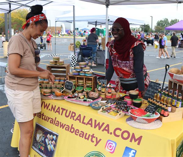 An attendee peruses the wares at the AWA Natural Beauty products booth.