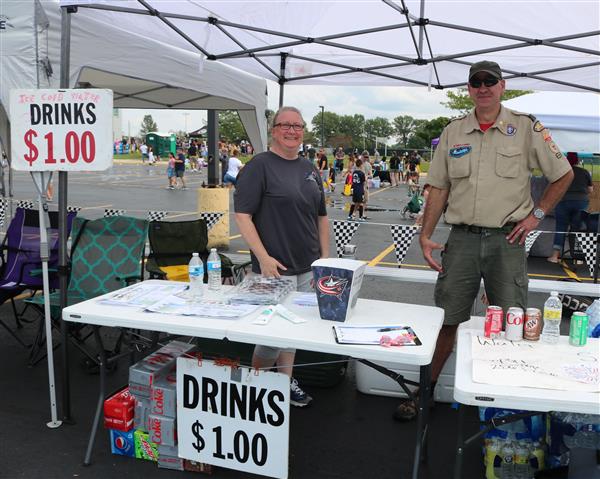 Two members of Boy Scouts selling water at the Family & Community Festival.