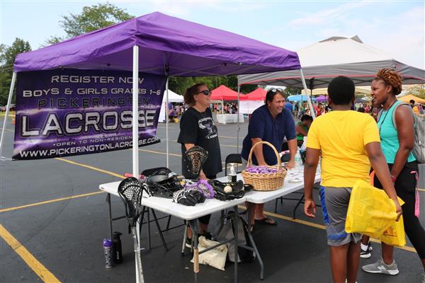 Potential lacrosse players at the LaxCats Youth Lacrosse vendor booth.